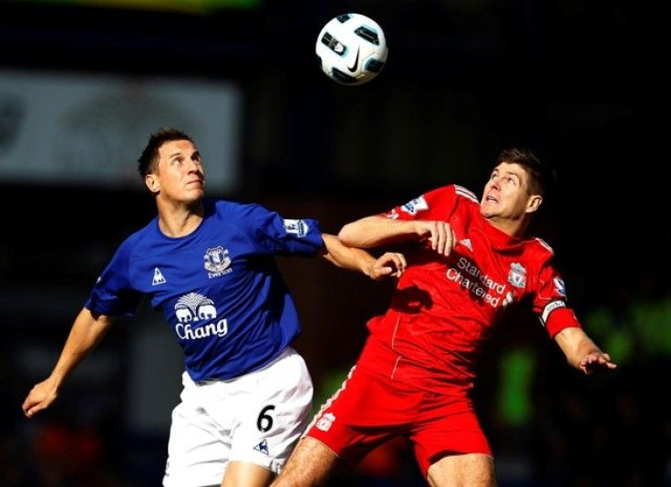 Everton's Jagielka challenges Liverpool's Gerrard during their English Premier League soccer match at Goodison Park in Liverpool.