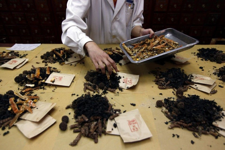 A worker prepares traditional Chinese herbal medicines at Beijing&#039;s Capital Medical University Traditional Chinese Medicine Hospital