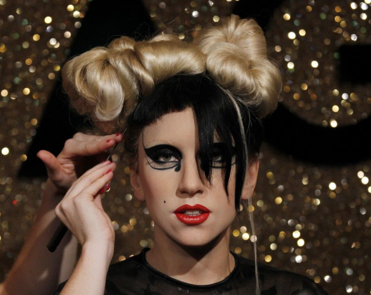 An artist puts finishing touches to a wax figure of singer Lady Gaga before the opening of Madame Tussauds' Japan exhibition, in Tokyo