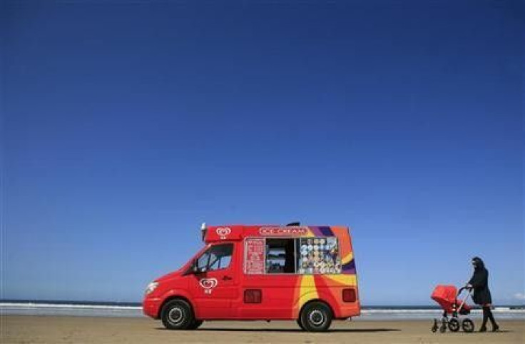 A woman pushes her pram towards an ice cream vendor on Portstewart Strand beach, Northern Ireland, May 10, 2009.