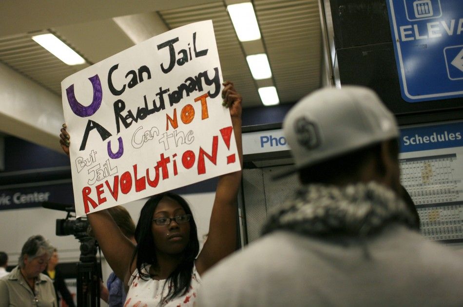 A protester holds up a sign on a BART train during a demonstration at the Civic Center Station in San Francisco