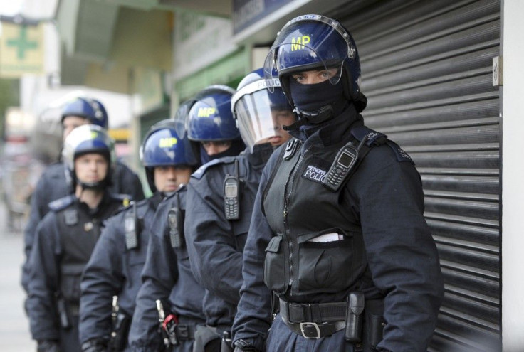 Police officers prepare to carry out a raid in Pimlico, London