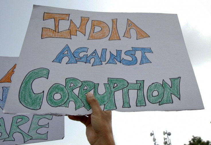 Supporters of Anna Hazare wave placards during a protest rally against corruption in Mumbai
