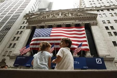 Two children sit on a bench outside the New York Stock Exchange