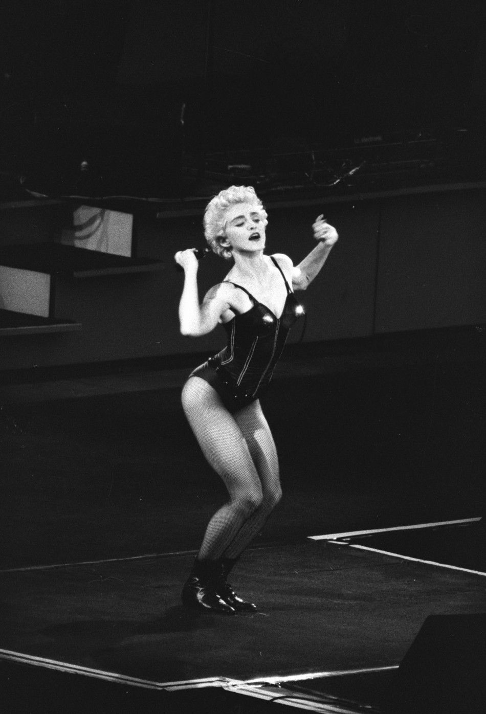 Madonna dances before a crowd of 77,000 fans at Wembley Stadium in London
