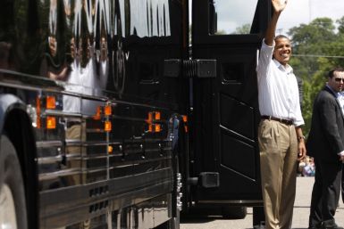 U.S. President Obama waves alongside his bus in Cannon Falls