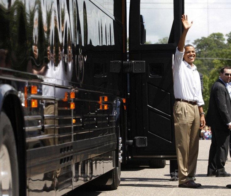 U.S. President Obama waves alongside his bus in Cannon Falls