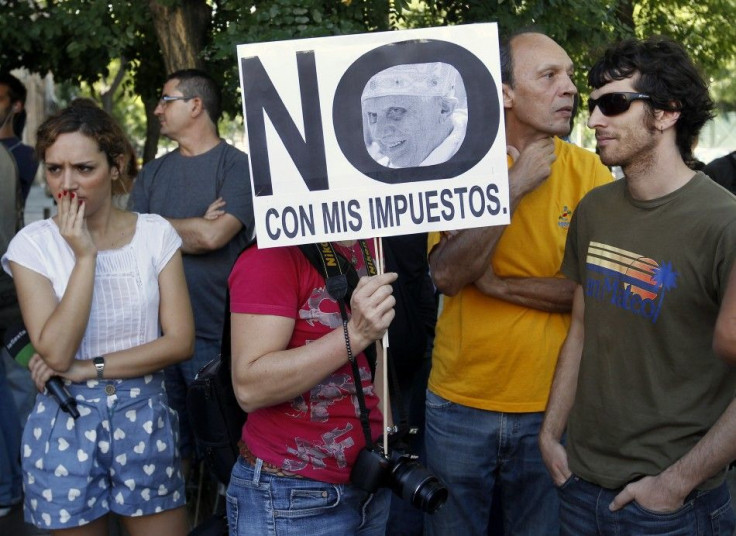 Demonstrators protest against special reductions on public transport for visiting pilgrims on the first day of the World Youth Day meeting in Madrid