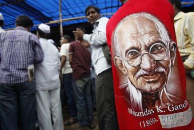 A supporter of veteran Indian social activist Anna Hazare wearing t-shirt with portrait of Mahatma Gandhi participates in a protest rally against corruption in Mumbai