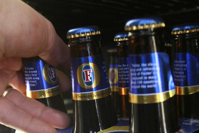 A customer takes a six-pack of Foster&#039;s beer from the fridge at a liquor store in Melbourne