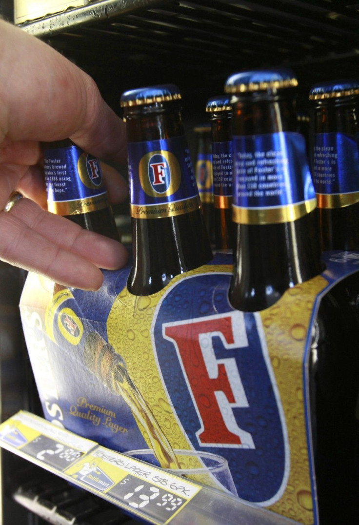 A customer takes a six-pack of Foster&#039;s beer from the fridge at a liquor store in Melbourne