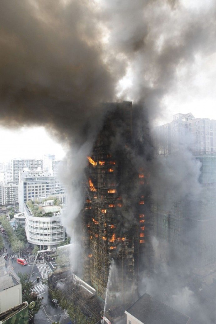 Firefighters try to extinguish a fire at a building in Shanghai 