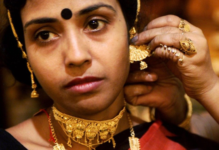 Indian woman tries on gold jewelry