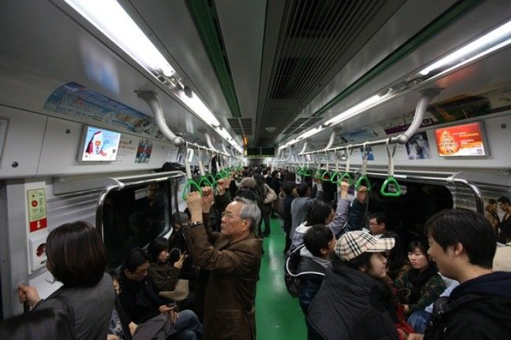 People ride on a subway train in Seoul November 13, 2010.