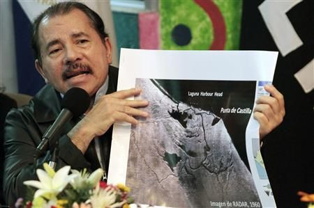 Nicaragua's President Daniel Ortega shows a map referring to the territorial dispute with Costa Rica during an address to the nation in Managua