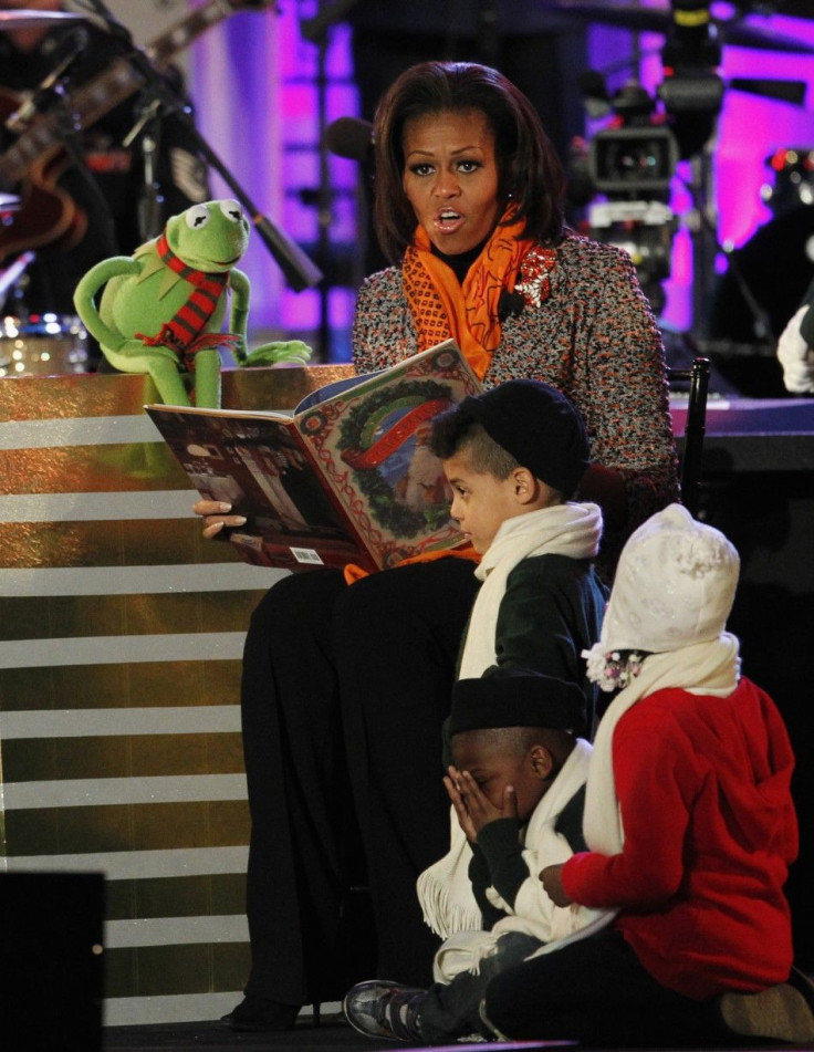 U.S. first lady Michelle Obama reads a Christmas story to children with the help of Kermit the Frog character, during the National Christmas Tree lighting ceremony in Washington