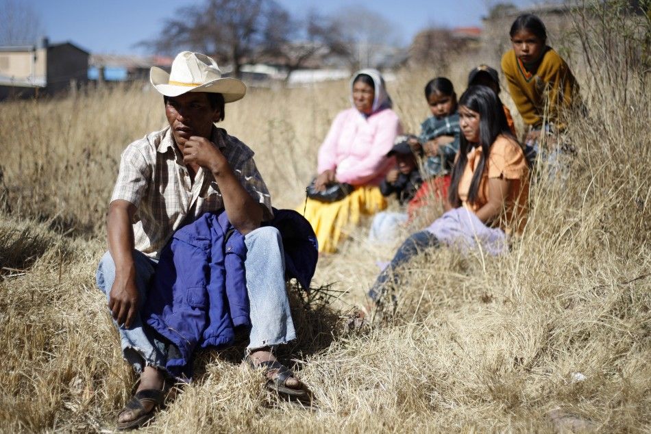 A Tarahumara Indigenous family sits together in Guachochi