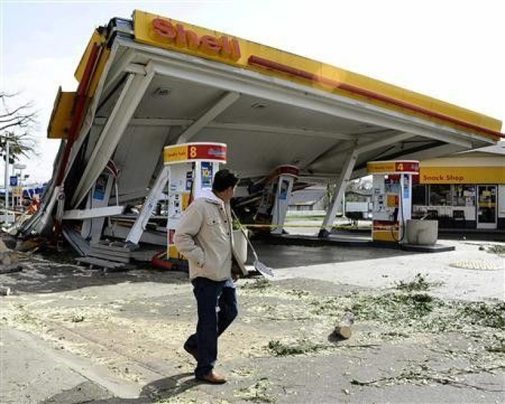 A man walks past a gasoline station that was damaged during a high wind storm in Pasadena, California