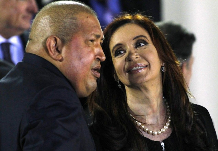 Venezuelan President Chavez chats with his Argentinian counterpart Fernandez during the family photo session of the CELAC summit in Caracas