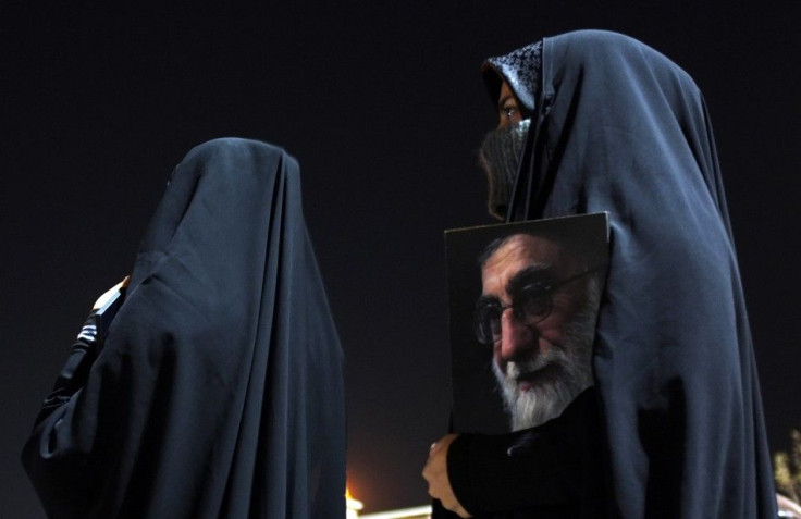 Members of the Basij militia wait outside Tehran&#039;s Mehrabad airport to welcome diplomats expelled from Britain