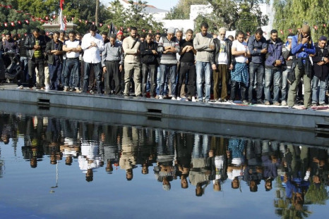 Islamists pray during a protest outside the parliamentary building in Tunis