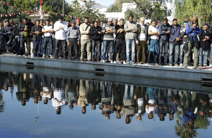 Islamists pray during a protest outside the parliamentary building in Tunis