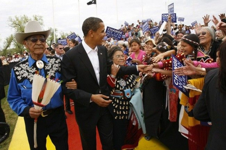 Then US Democratic presidential candidate and US Senator Barack Obama, (D-IL), arrives with Hartford and Mary Blackeagle, his new Crow &quot;parents&quot; who adopted him as a member of the Crow nation, for a campaign rally in Crow Agency, Montana May 19,