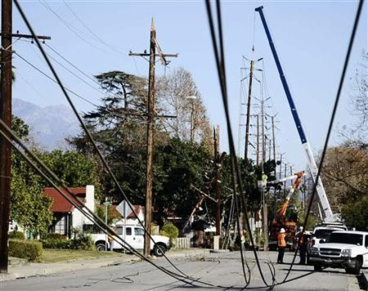Workers repair power lines downed by heavy winds at Temple City in California