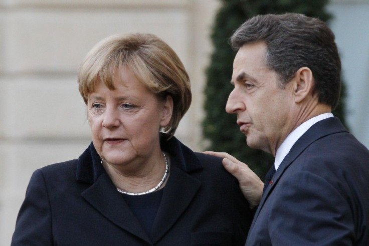 France's President Sarkozy escorts German Chancellor Merkel at the Elysee Palace following a joint news conference in Paris