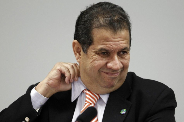 Brazil&#039;s Labor Minister Carlos Lupi adjusts his collar as he talks about allegations of irregularities in the Ministry of Labor during a meeting of the Commission for Financial Supervision and Control of the Chamber of Deputies in Brasilia