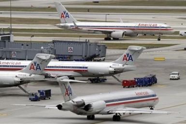 American Airlines planes sit at their gates while others taxi for arrival and departure at O'Hare International airport in Chicago
