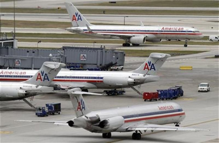 American Airlines planes sit at their gates while others taxi for arrival and departure at O'Hare International airport in Chicago