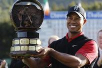 Tiger Woods of the U.S. holds up the trophy after winning the final round of the Chevron World Challenge PGA golf tournament with a birdie on the 18th hole in Thousand Oaks, California
