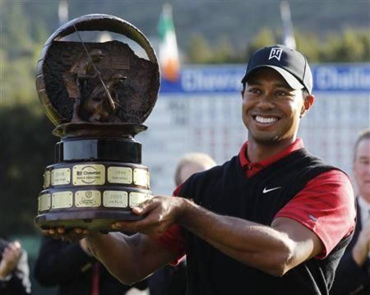 Tiger Woods of the U.S. holds up the trophy after winning the final round of the Chevron World Challenge PGA golf tournament with a birdie on the 18th hole in Thousand Oaks, California