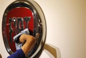 A worker polishes a Fiat logo during the launch of Chrysler-s flagship showroom in Los Angeles November 16, 2010. 