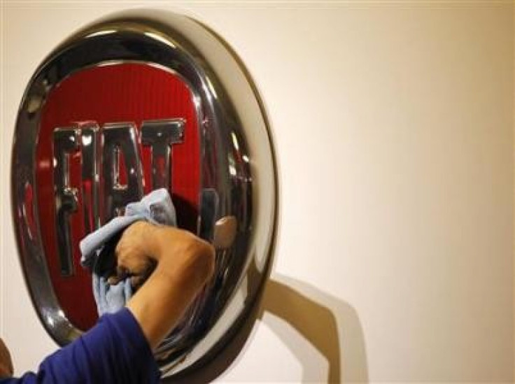 A worker polishes a Fiat logo during the launch of Chrysler-s flagship showroom in Los Angeles November 16, 2010. 
