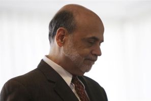 Federal Reserve Chairman Ben Bernanke waits to be introduced at a conference in Washington