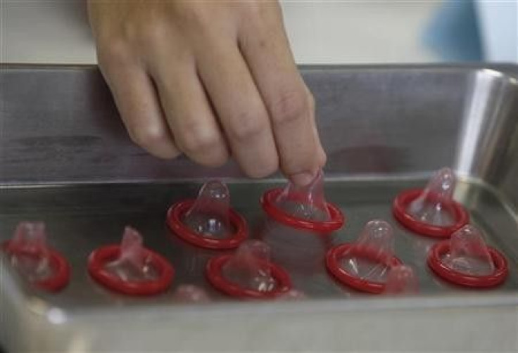 A health official inspects a condom at the Department of Medical Sciences laboratory in Nonthaburi province, on the outskirts of Bangkok September 27, 2010.