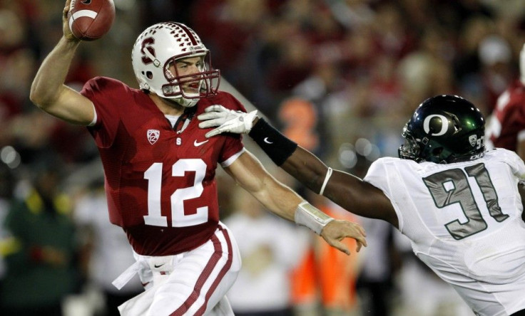 Stanford University quarterback Andrew Luck (12) dodges an attempted tackle by University of Oregon defensive end Tony Washington (91) during the second quarter of their NCAA football game against the University of Oregon in Palo Alto