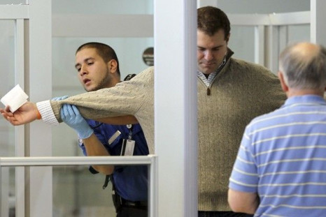 A U.S. Transportation Security Administration (TSA) officer carries out a physical search on a passenger at a security checkpoint at Newark Liberty International Airport in New Jersey December 29, 2009. 