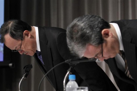 Olympus Corp President Takayama and accounting division&#039;s official Onishi bow at the start of a news conference in Tokyo