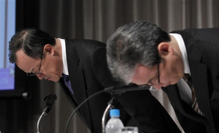 Olympus Corp President Takayama and accounting division&#039;s official Onishi bow at the start of a news conference in Tokyo