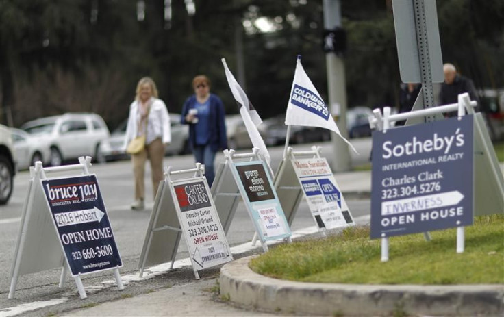 Signs advertising open houses for real estate sale are seen in Los Angeles