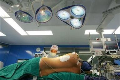 A patient is prepared for a two-hour surgery that will involve injecting stem cells cultivated from the patient's blood, at Bangkok Heart Hospital, in December 2005.
