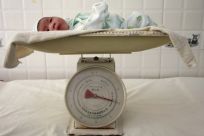 A newborn baby is put on a scale at a hospital in Suining