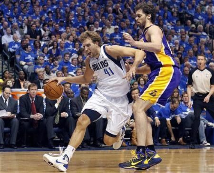Dallas Mavericks power forward Dirk Nowitzki (L) drives the ball around Los Angeles Lakers power forward Pau Gasol in the first quarter during Game 3 of the NBA Western Conference semi-final basketball playoff in Dallas, Texas