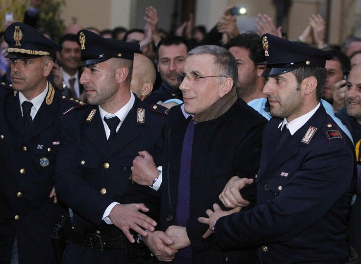 Italian police officers lead mafia boss Michele Zagaria from a police station in the southern city of Caserta