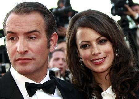Cast members Jean Dujardin (L) and Berenice Bejo pose as they arrive on the red carpet for the screening of the film ''The Artist'' by director Michel Hazanavicius in competition at the 64th Cannes Film Festival