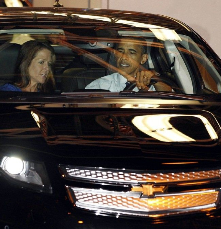 U.S. President Barack Obama sits next to plant manager Teri Quigley (L) as he drives a Volt car off the assembly line at a General Motors Auto Plant in Hamtramck, Michigan, near Detroit, July 30, 2010.
