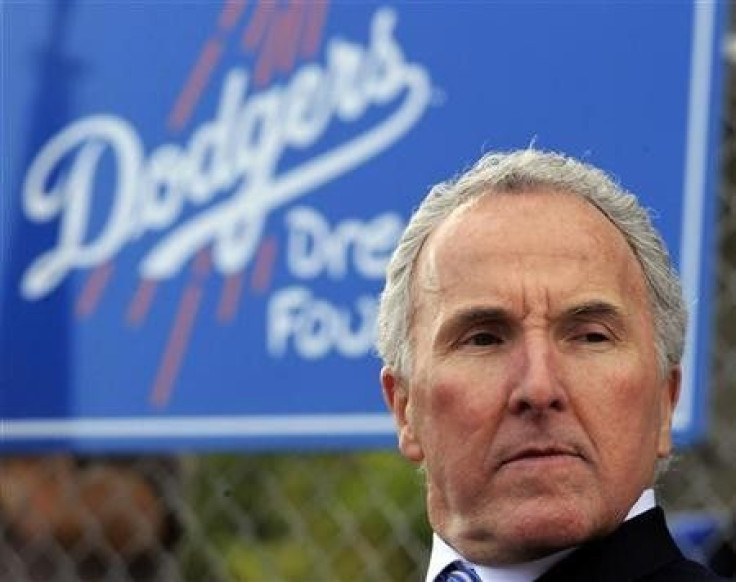 Los Angeles Dodgers owner Frank McCourt listens during the unveiling of a new Dodgers baseball field for children in Compton, Los Angeles, California